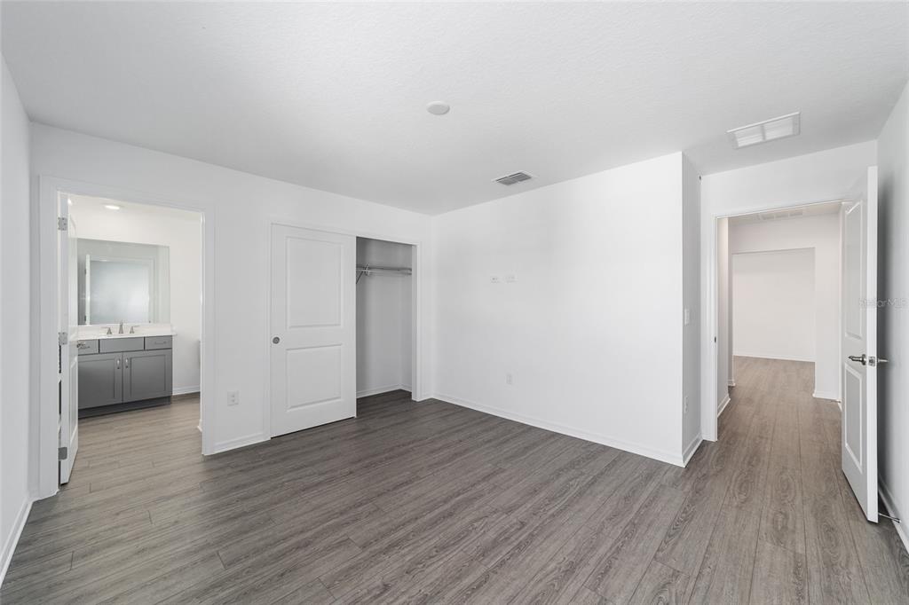 7232 Southwest 63rd Street Ocala, FL 34474 - Photo 46 of 54 a view of a hallway with wooden floor and a bathroom