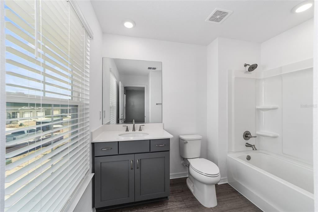 7232 Southwest 63rd Street Ocala, FL 34474 - Photo 47 of 54 a bathroom with a toilet a sink a tub and mirror
