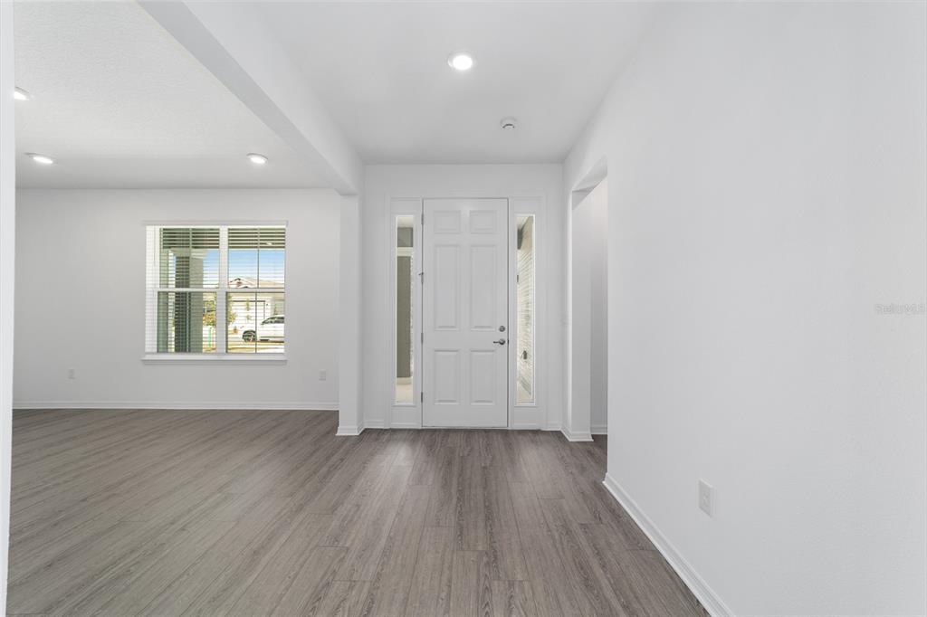 7232 Southwest 63rd Street Ocala, FL 34474 - Photo 7 of 54 an empty room with wooden floor and windows