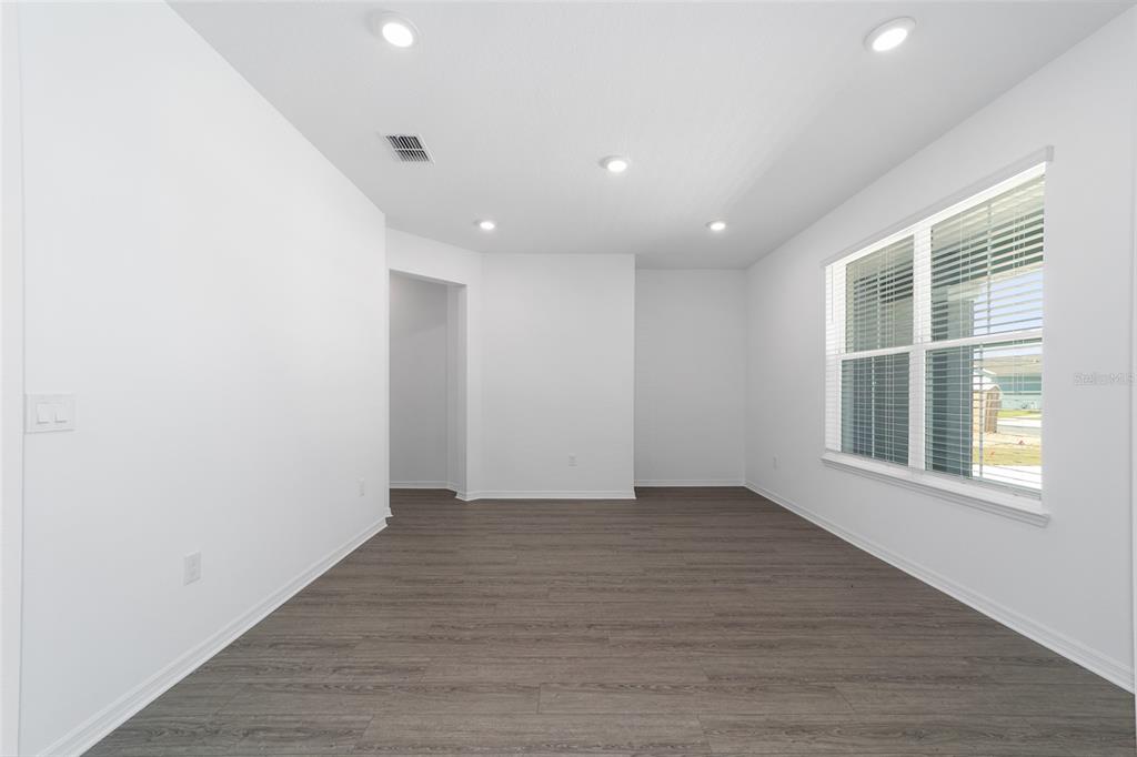 7232 Southwest 63rd Street Ocala, FL 34474 - Photo 8 of 54 an empty room with wooden floor and windows