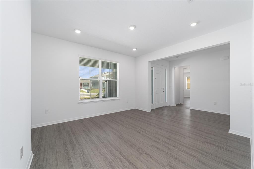 7232 Southwest 63rd Street Ocala, FL 34474 - Photo 9 of 54 an empty room with wooden floor and windows