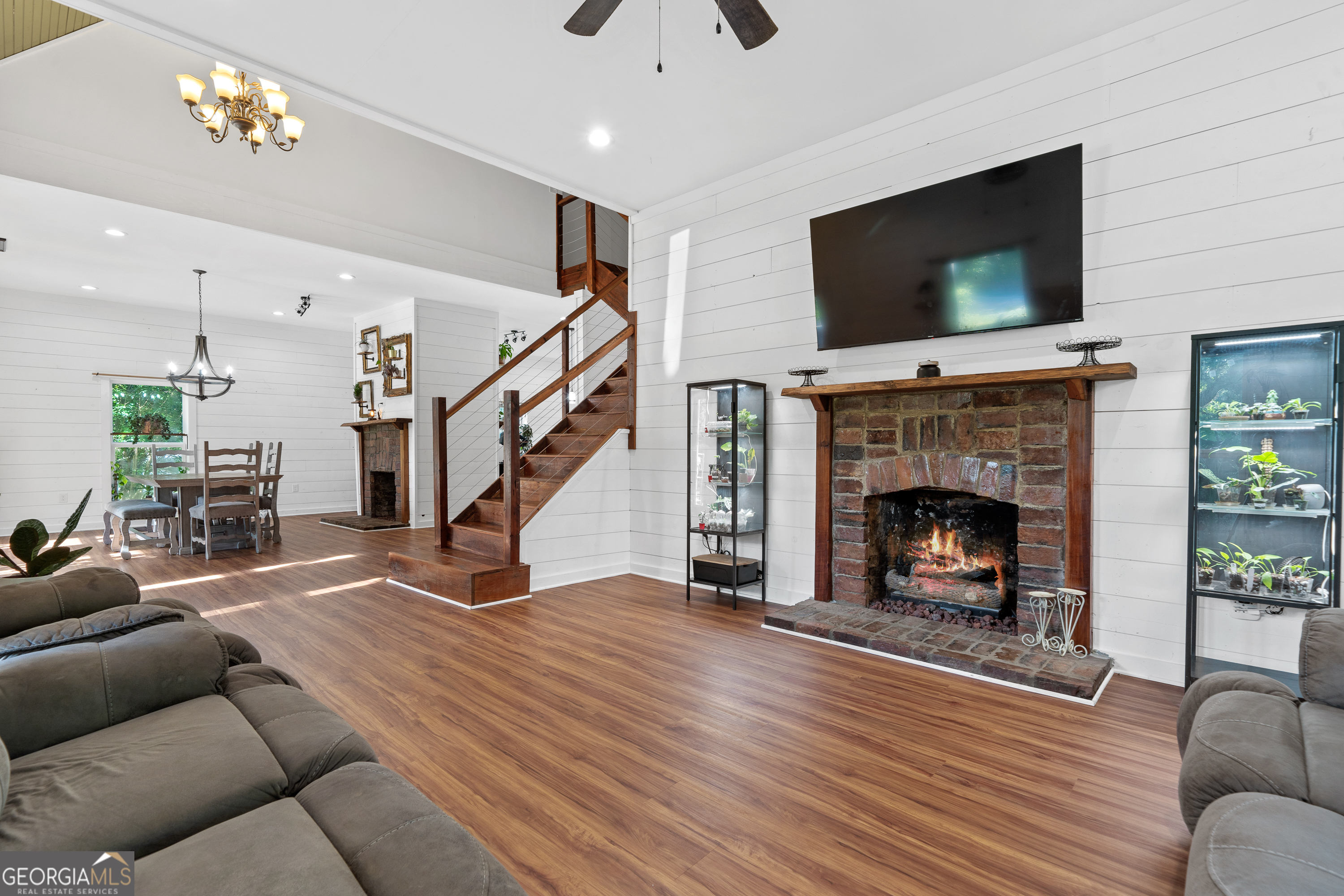 7170 Church Street Bartow, GA 30413 - Photo 11 of 49 a living room with furniture a flat screen tv and a fireplace