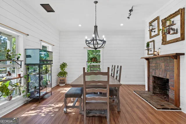 a view of a dining room with furniture wooden floor and chandelier