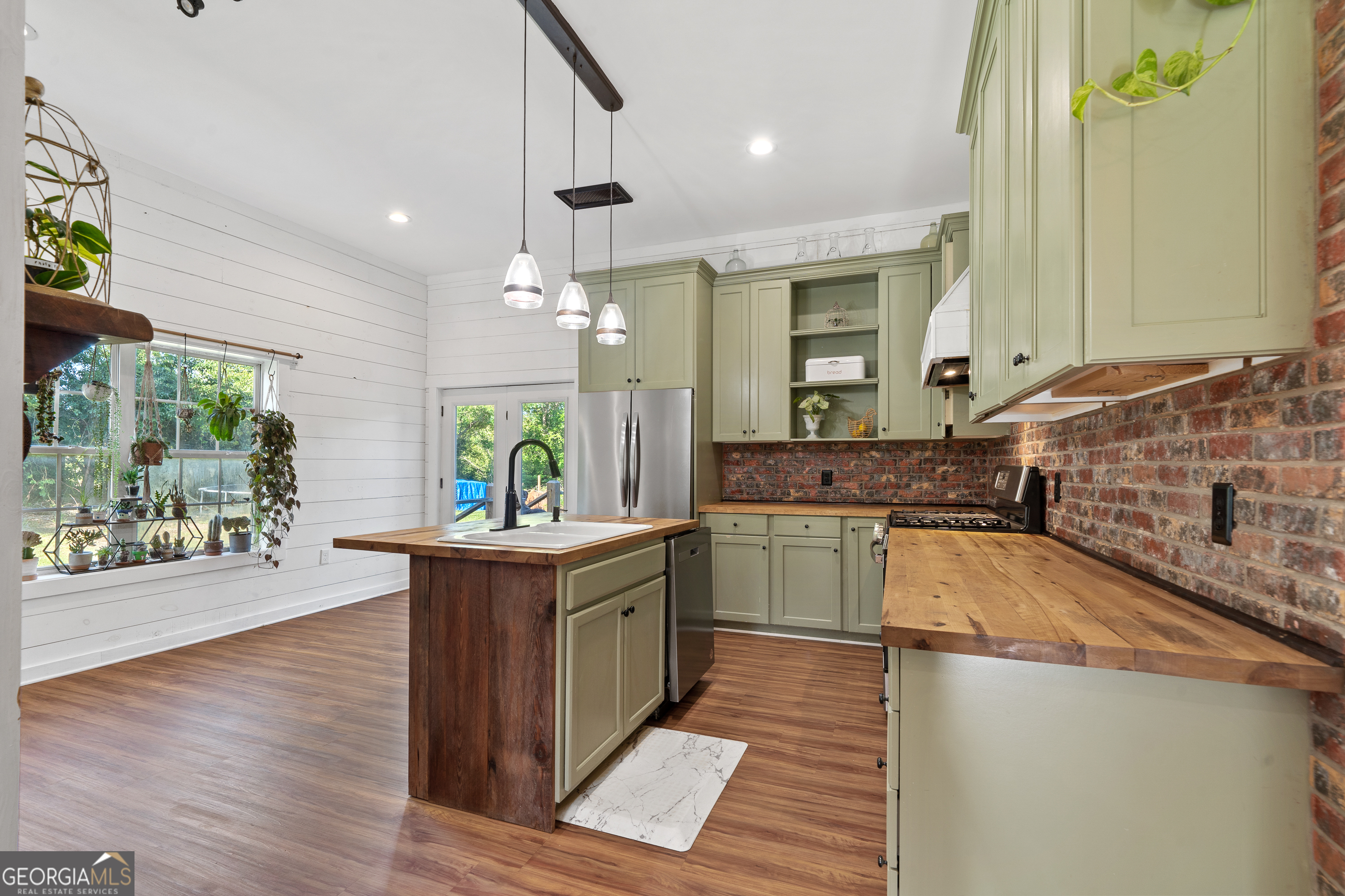 7170 Church Street Bartow, GA 30413 - Photo 19 of 49 a kitchen with stainless steel appliances granite countertop a sink stove and wooden cabinets