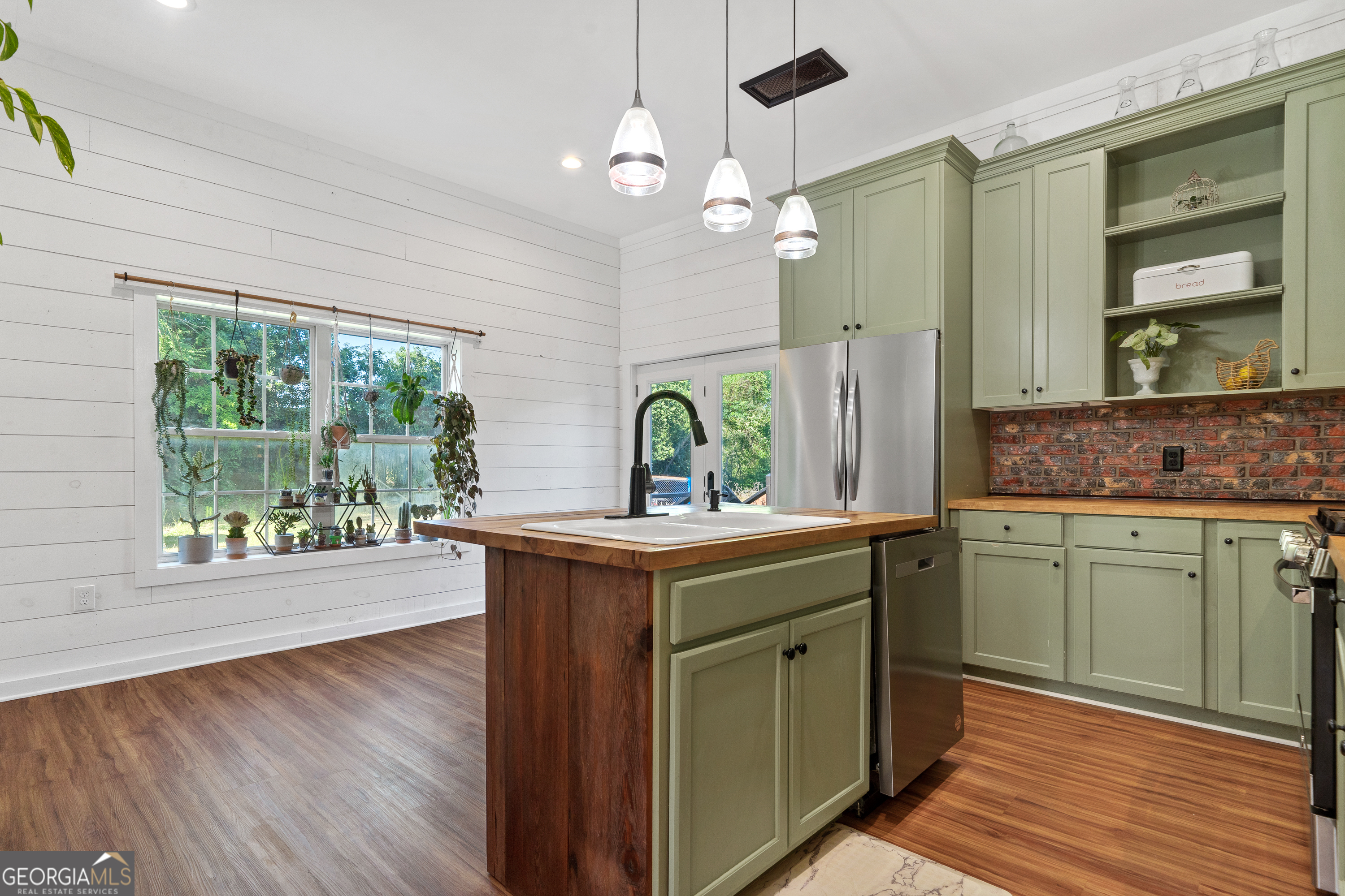 7170 Church Street Bartow, GA 30413 - Photo 21 of 49 a kitchen with a sink and wooden floor