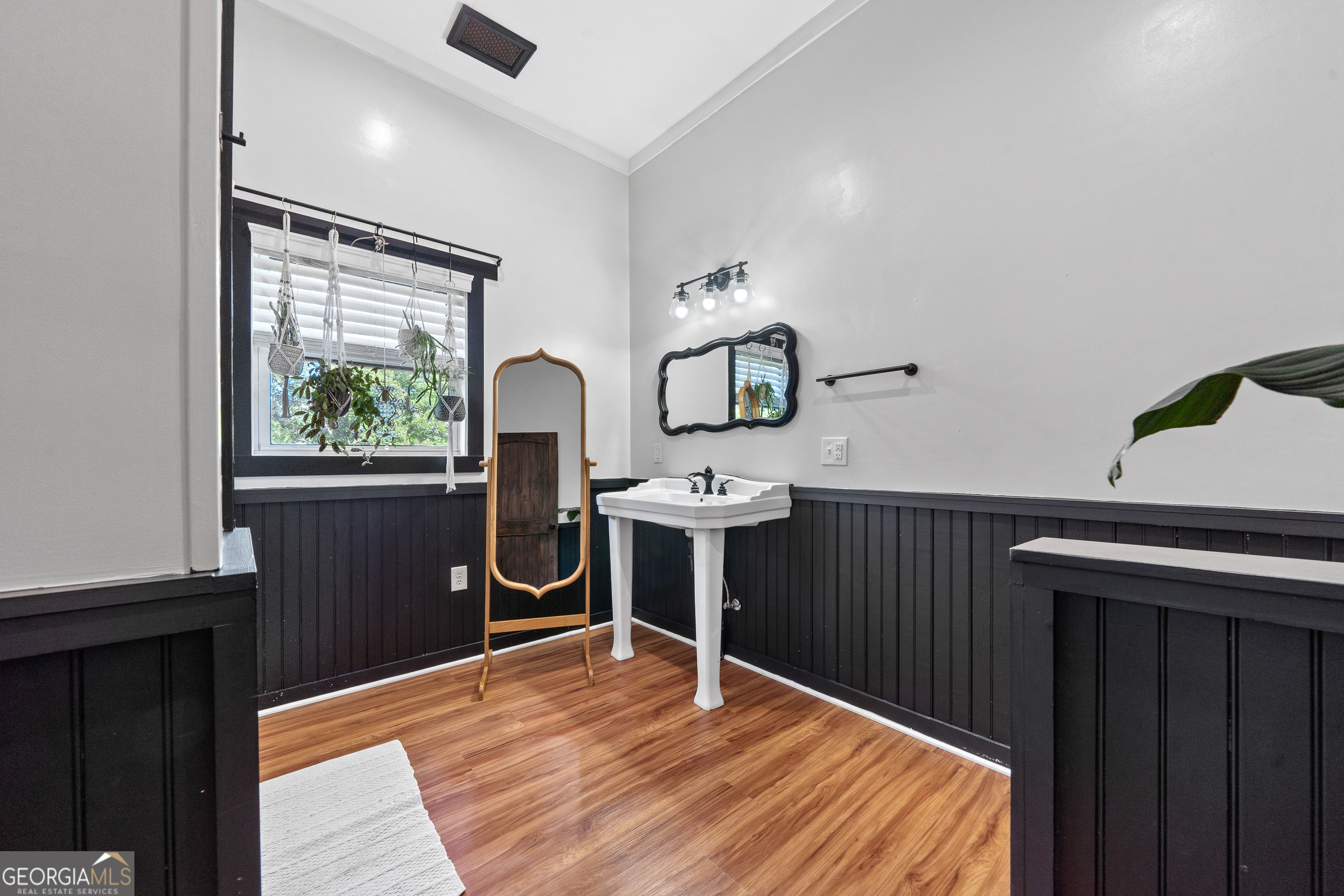 7170 Church Street Bartow, GA 30413 - Photo 27 of 49 a bedroom with a bed and wooden floor