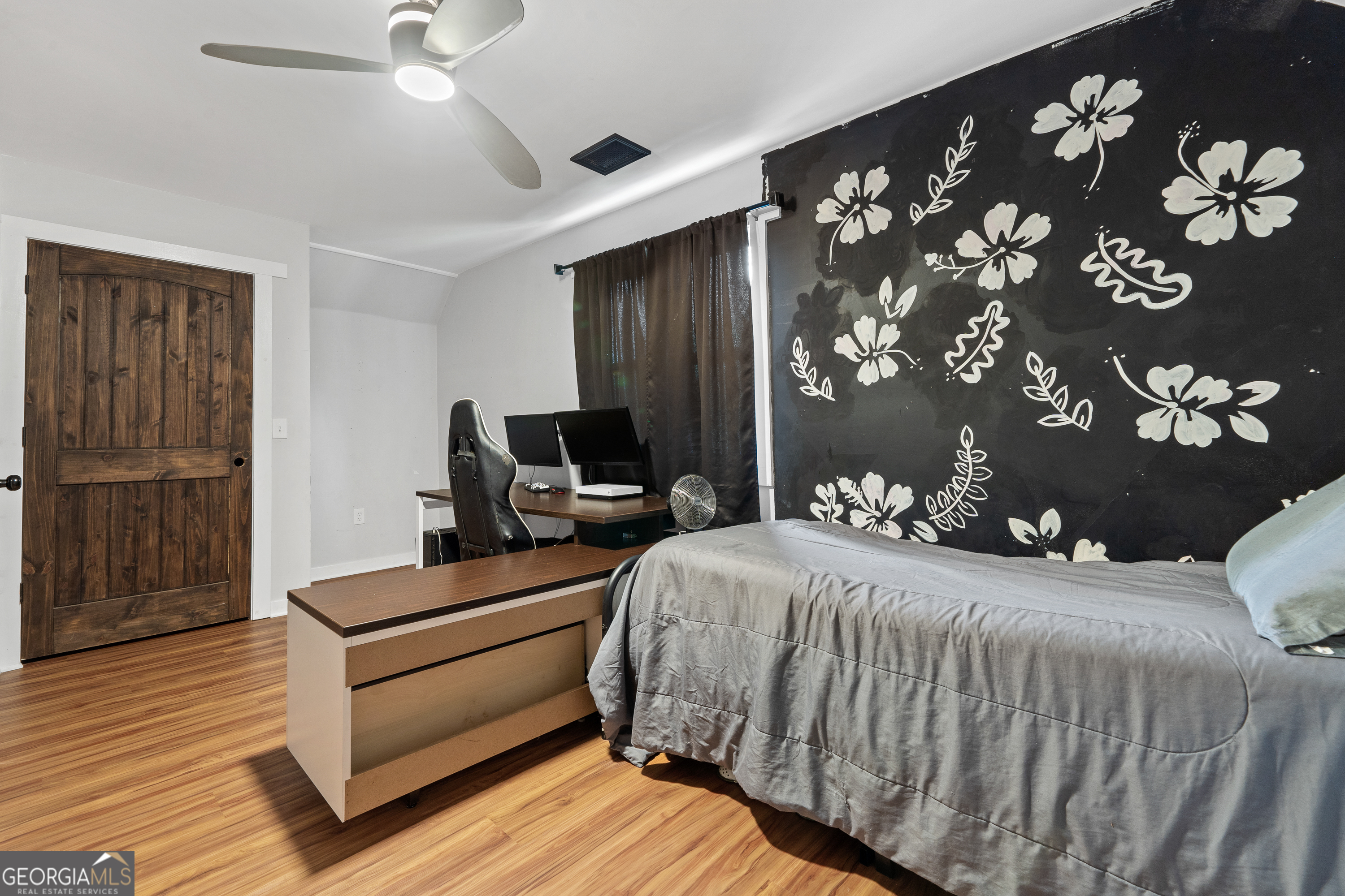 7170 Church Street Bartow, GA 30413 - Photo 42 of 49 a bedroom with a bed dresser and wooden floor