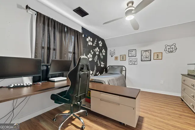 a work room with furniture and wooden floor