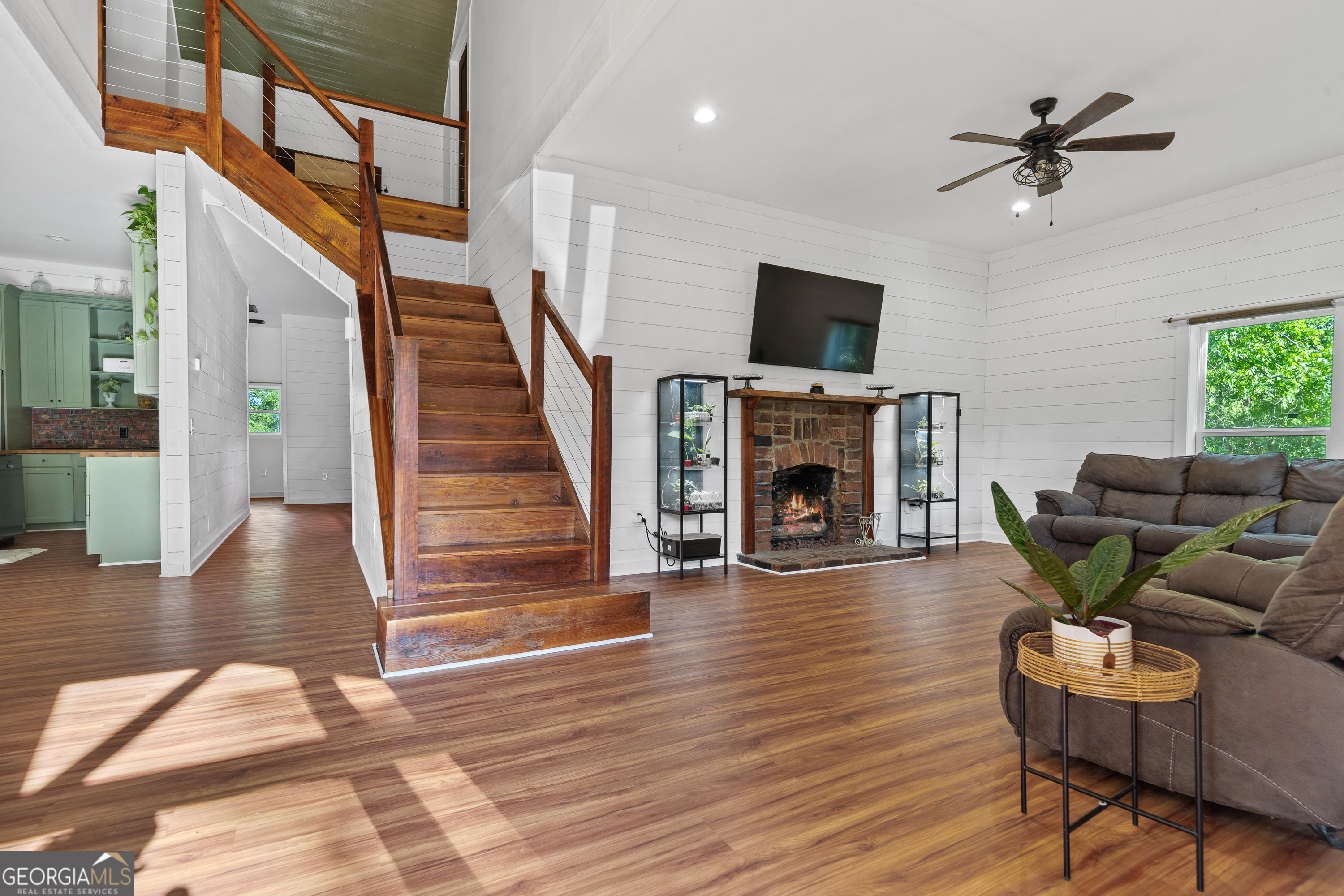 7170 Church Street Bartow, GA 30413 - Photo 5 of 49 a living room with furniture a fireplace and a flat screen tv