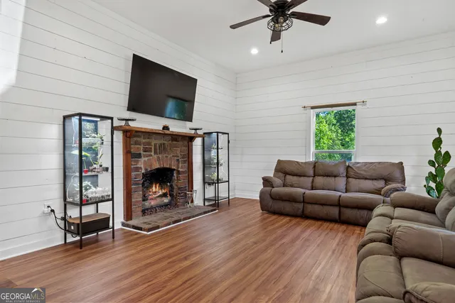 a living room with furniture a flat screen tv and a fireplace