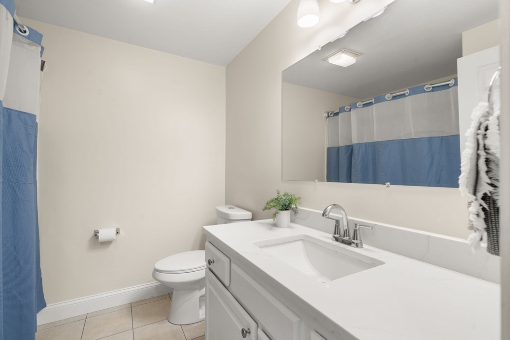 154 Danforth Street Framingham, MA 01701 - Photo 11 of 30 a bathroom with a sink a toilet and shower