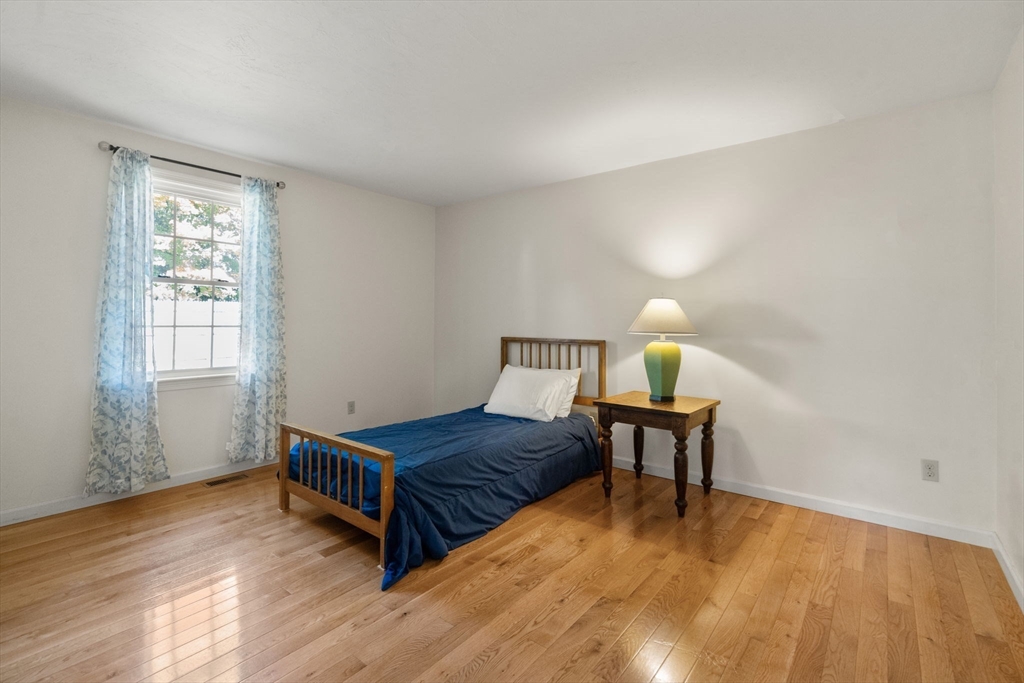 154 Danforth Street Framingham, MA 01701 - Photo 23 of 30 a bedroom with a bed window and wooden floor