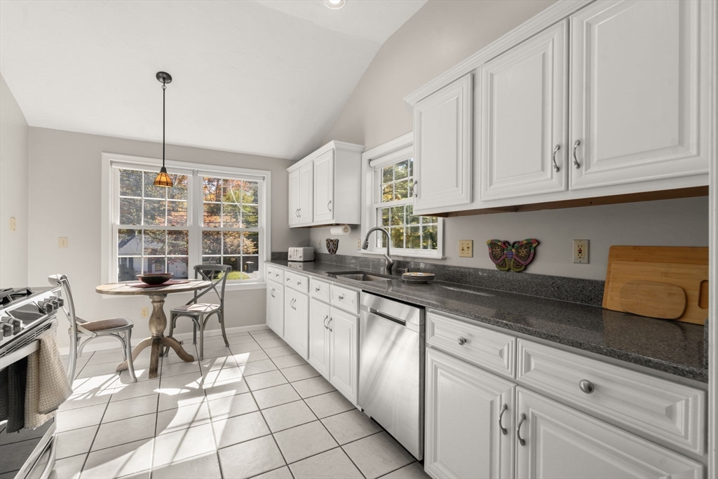 154 Danforth Street Framingham, MA 01701 - Photo 6 of 30 a open kitchen with granite countertop white cabinets and white appliances