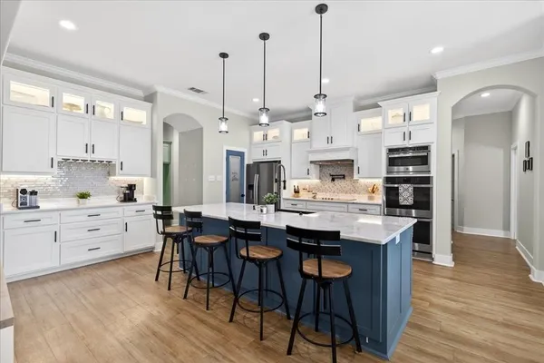 a large kitchen with a table and chairs