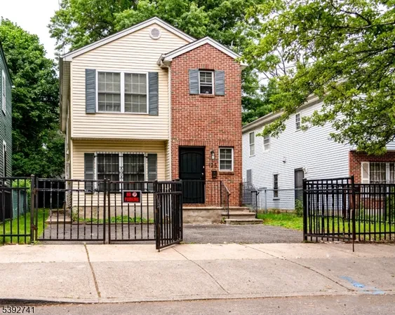 a front view of a house with a garden and plants