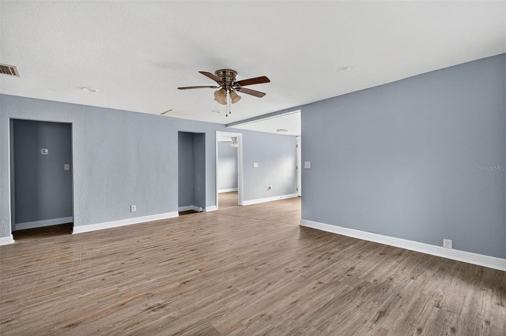 5801 Virginia Avenue New Port Richey, FL 34652 - Photo 14 of 81 a view of empty room with wooden floor and ceiling fan