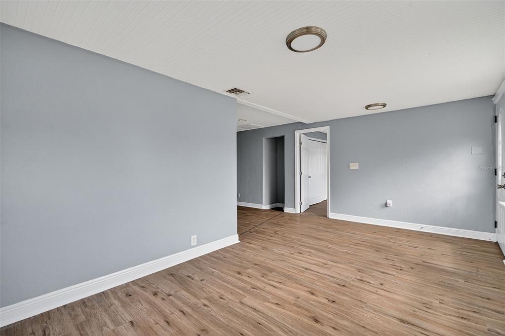 5801 Virginia Avenue New Port Richey, FL 34652 - Photo 15 of 81 a view of an empty room with wooden floor