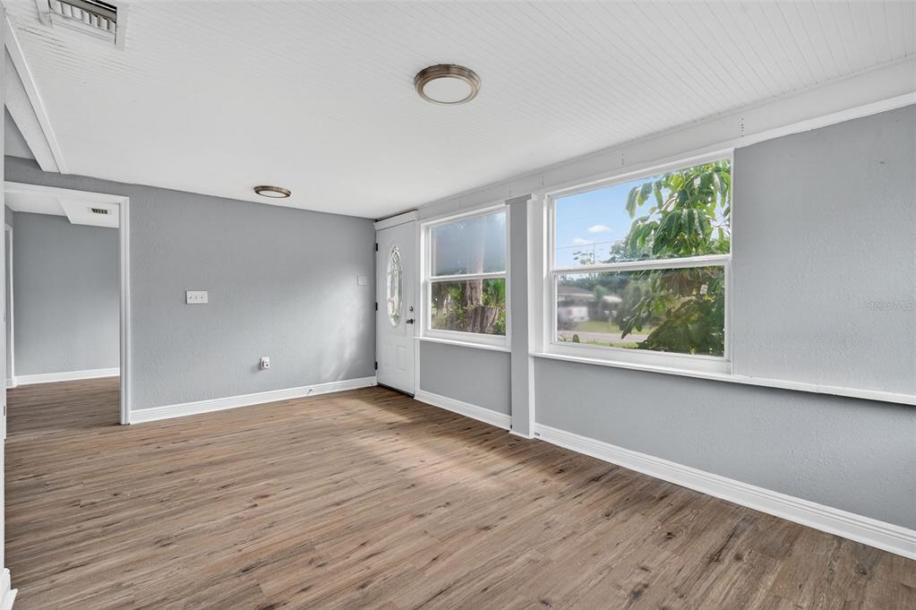 5801 Virginia Avenue New Port Richey, FL 34652 - Photo 16 of 81 an empty room with wooden floor and windows