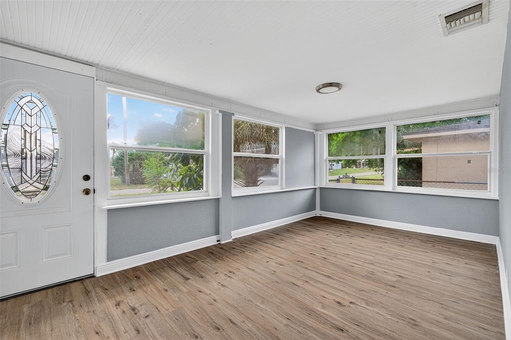 5801 Virginia Avenue New Port Richey, FL 34652 - Photo 17 of 81 an empty room with wooden floor and windows