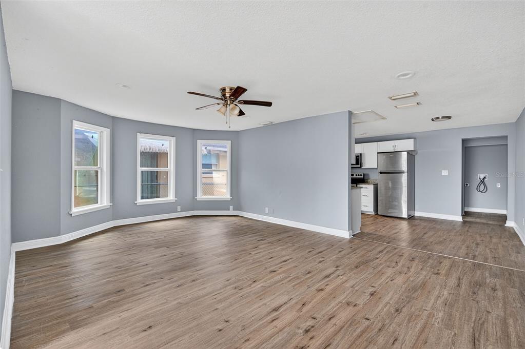 5801 Virginia Avenue New Port Richey, FL 34652 - Photo 21 of 81 a view of an empty room with a window and wooden floor