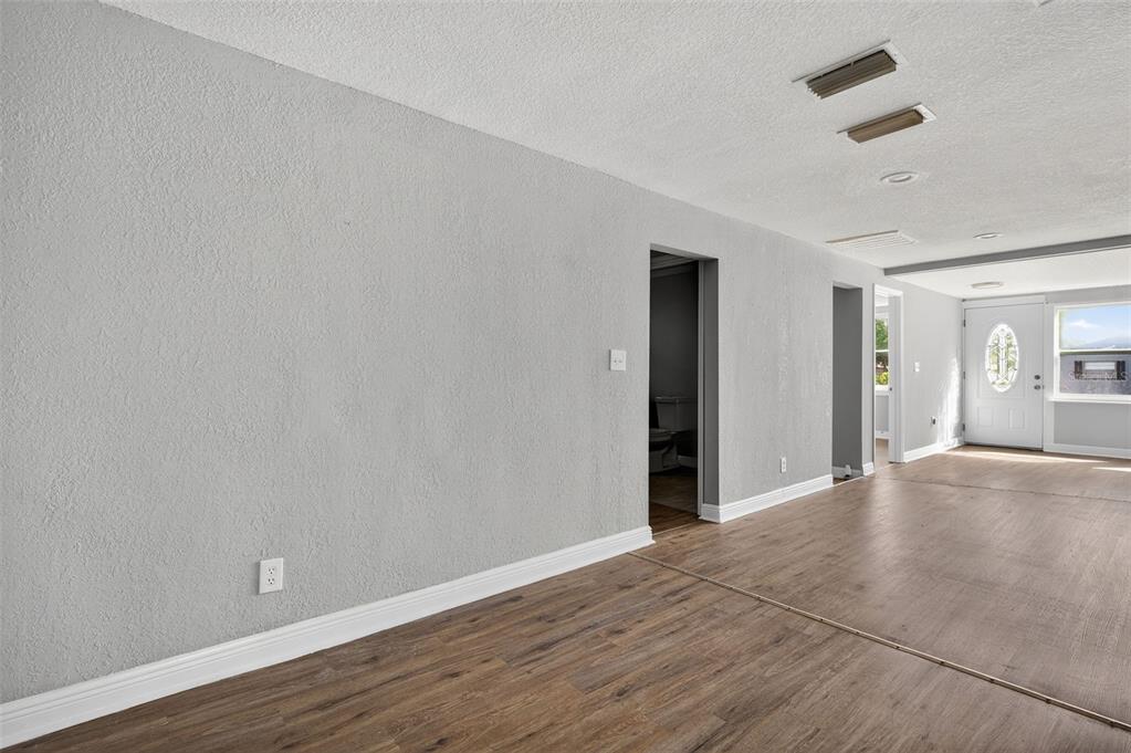 5801 Virginia Avenue New Port Richey, FL 34652 - Photo 28 of 81 an empty room with wooden floor and windows