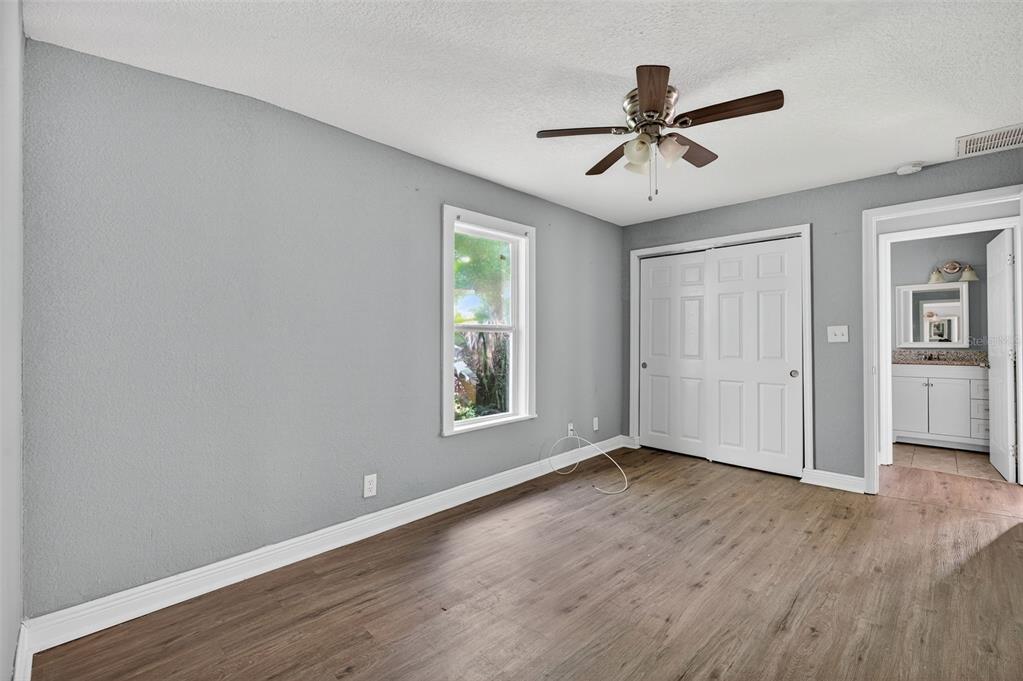 5801 Virginia Avenue New Port Richey, FL 34652 - Photo 33 of 81 a view of an empty room with wooden floor and a window