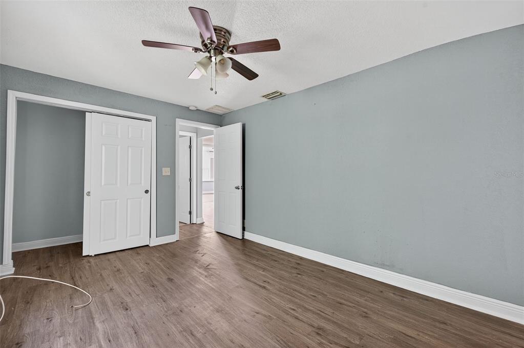 5801 Virginia Avenue New Port Richey, FL 34652 - Photo 35 of 81 a view of an empty room with wooden floor