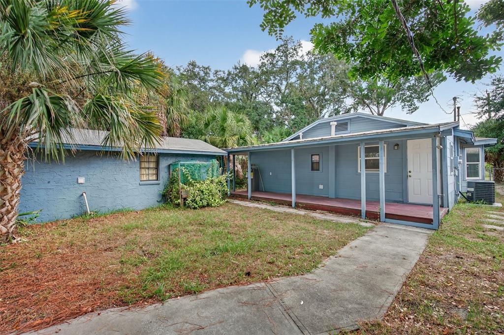 5801 Virginia Avenue New Port Richey, FL 34652 - Photo 41 of 81 a front view of a house with a garden and trees