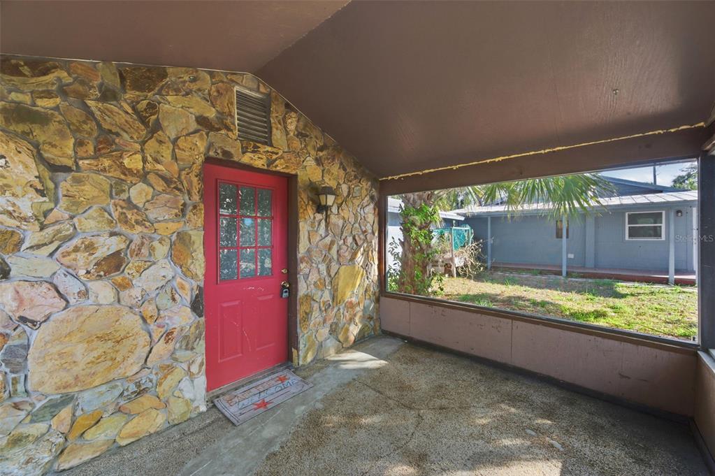 5801 Virginia Avenue New Port Richey, FL 34652 - Photo 50 of 81 a view of a porch with a table and chairs