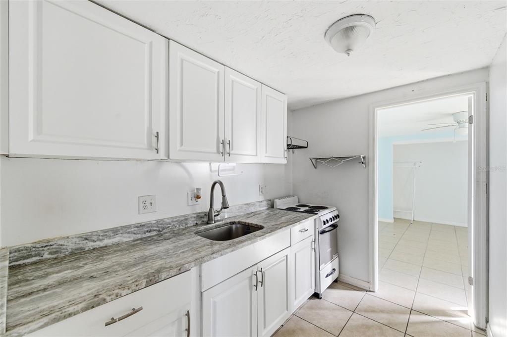 5801 Virginia Avenue New Port Richey, FL 34652 - Photo 55 of 81 a kitchen with stainless steel appliances granite countertop a sink and cabinets