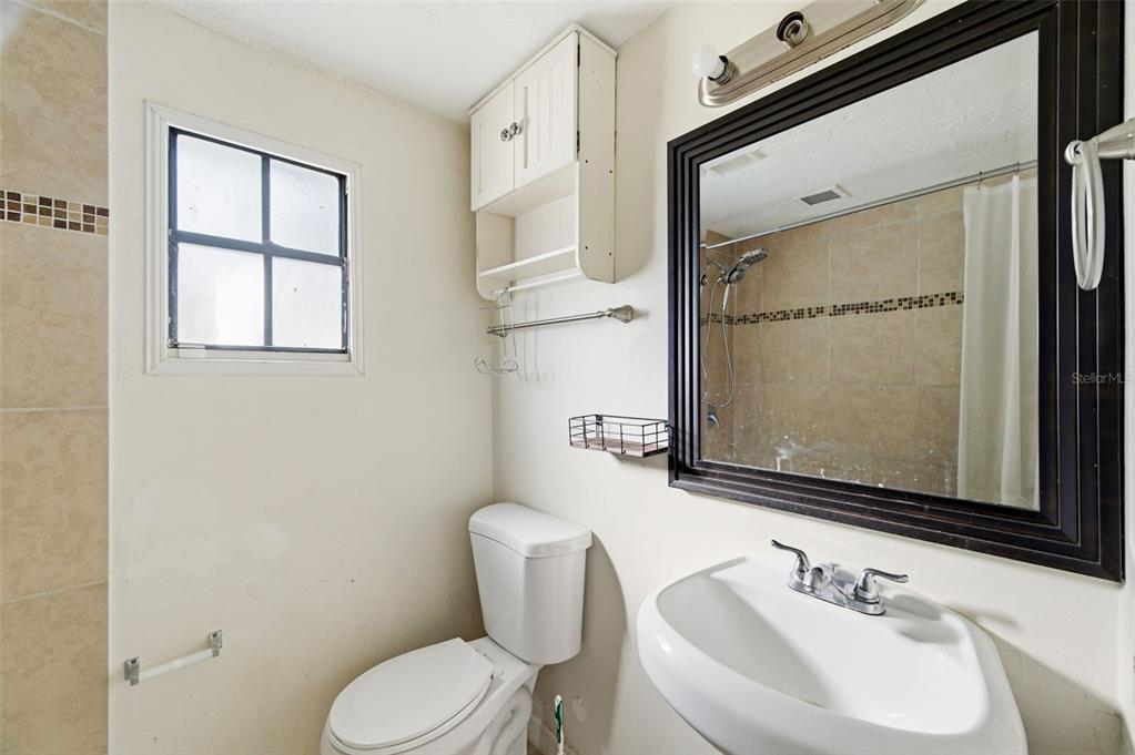 5801 Virginia Avenue New Port Richey, FL 34652 - Photo 60 of 81 a bathroom with a sink toilet and mirror