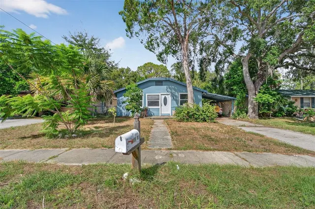 a view of empty room with wooden floor and ceiling fan