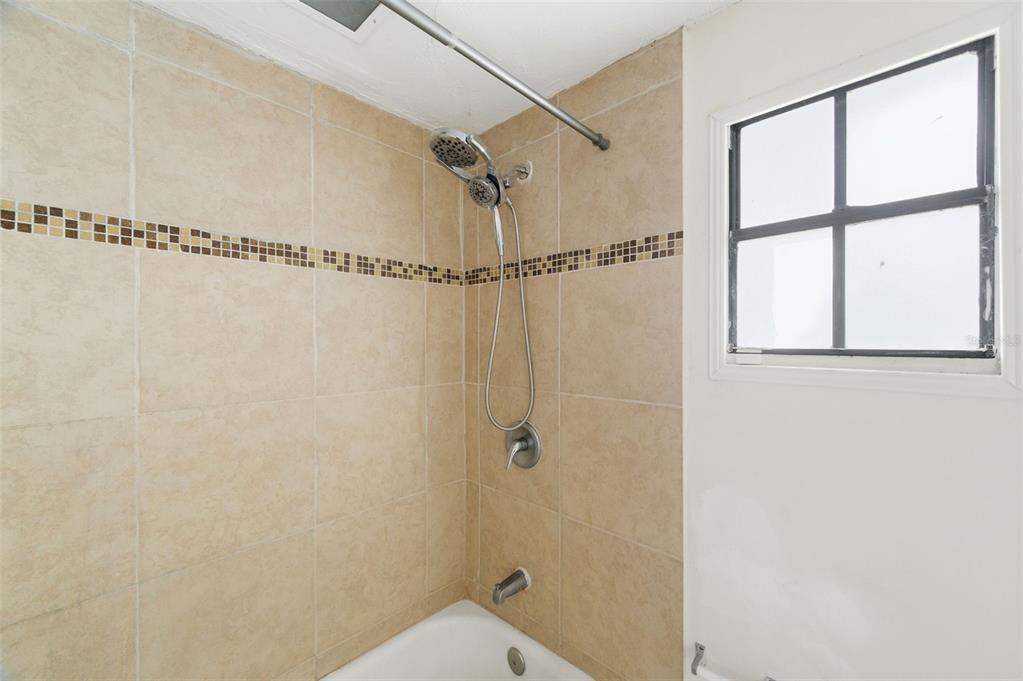 5801 Virginia Avenue New Port Richey, FL 34652 - Photo 61 of 81 a bathroom with a window and a shower