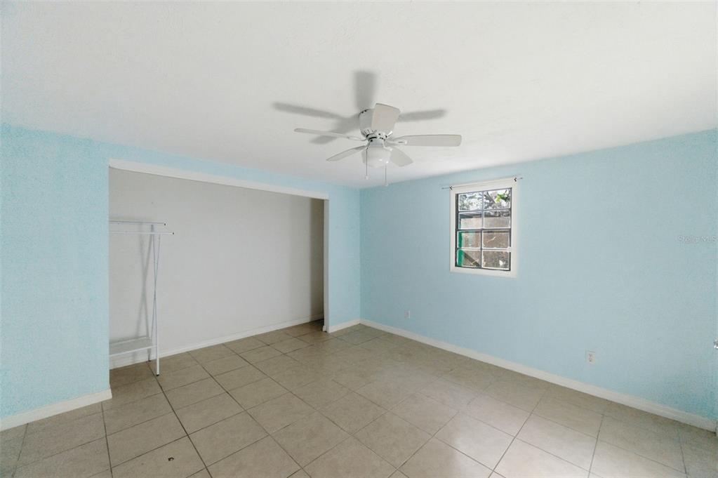 5801 Virginia Avenue New Port Richey, FL 34652 - Photo 62 of 81 a view of an empty room with a ceiling fan and a window