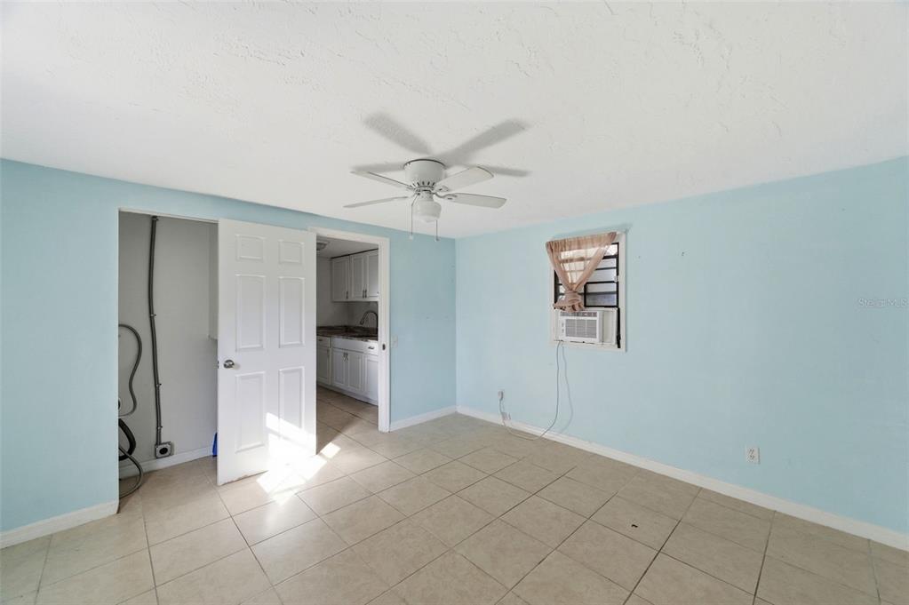 5801 Virginia Avenue New Port Richey, FL 34652 - Photo 64 of 81 a view of a big room with windows and chandelier fan