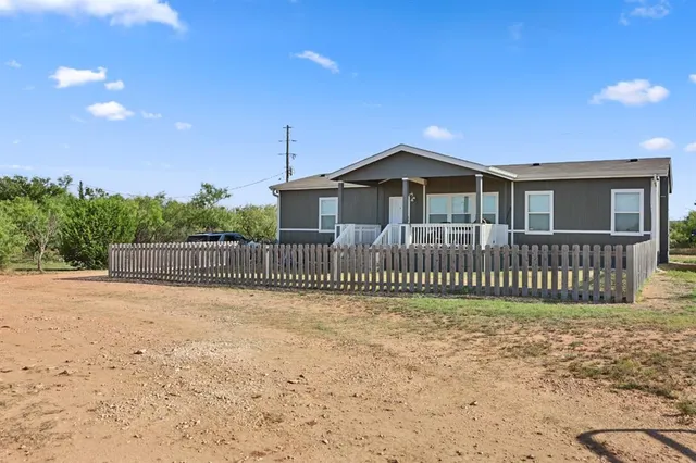 a view of a house with a fence
