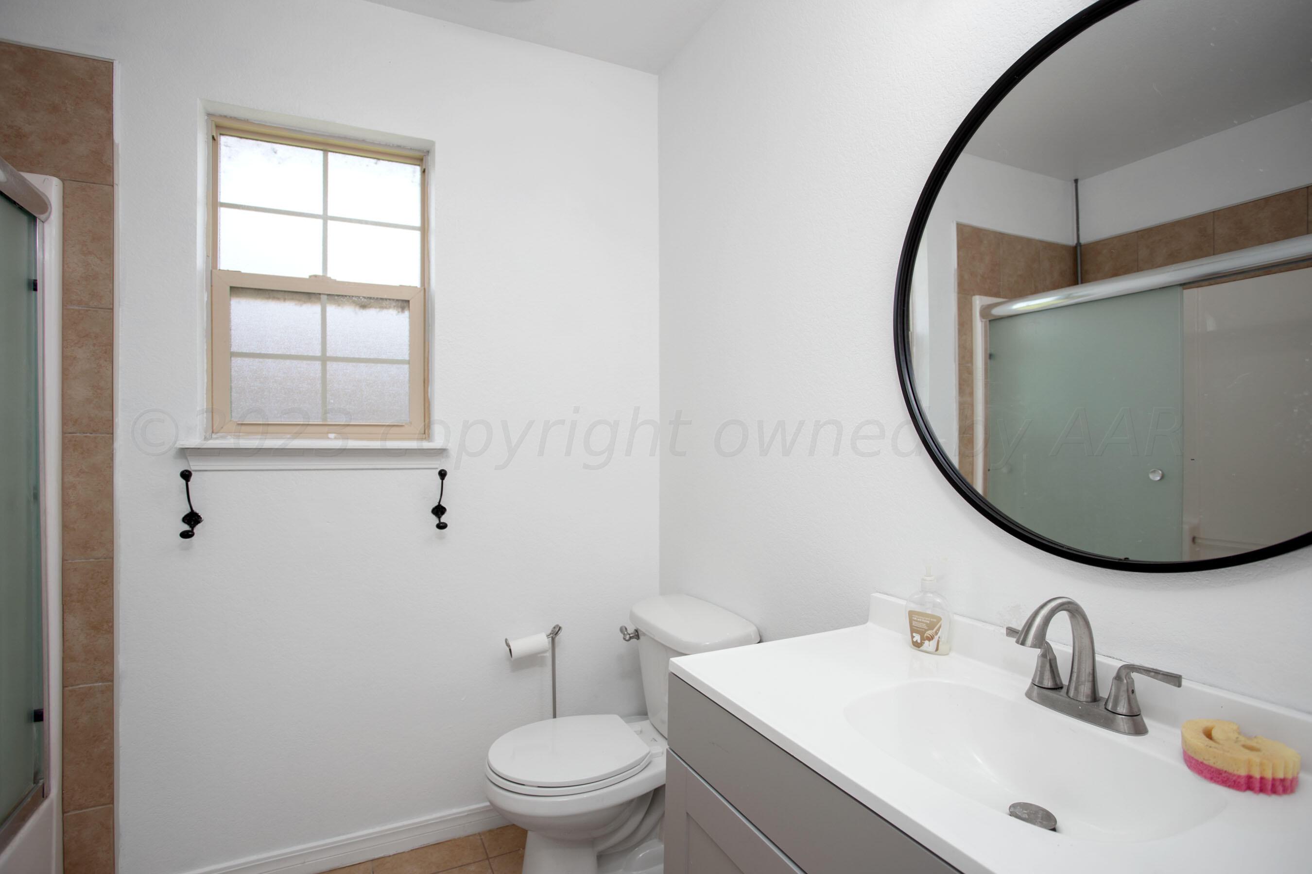 4511 South Roberts Street Amarillo, TX 79118 - Photo 18 of 26 a bathroom with a sink and a mirror