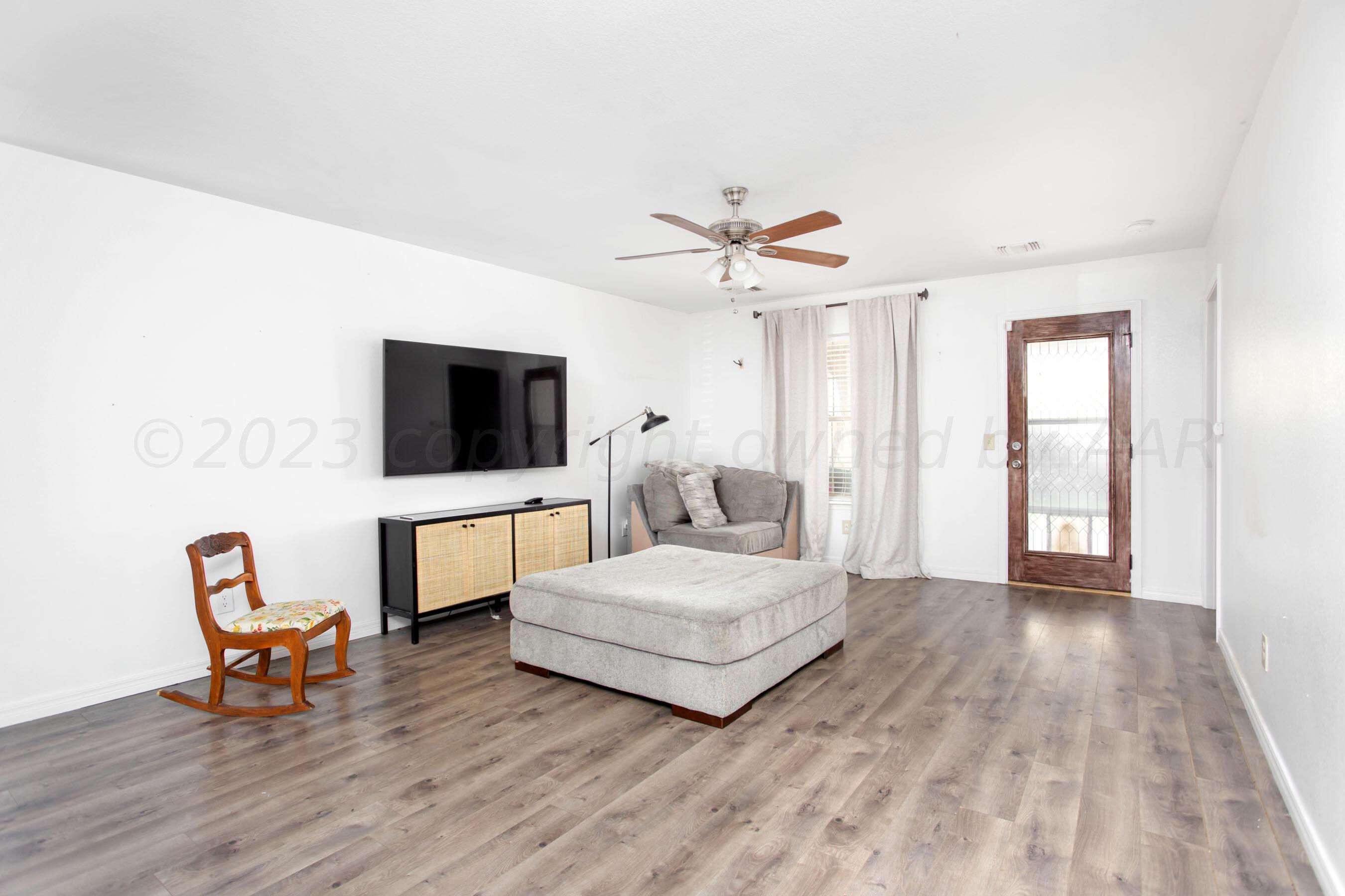 4511 South Roberts Street Amarillo, TX 79118 - Photo 4 of 26 a living room with furniture and a flat screen tv