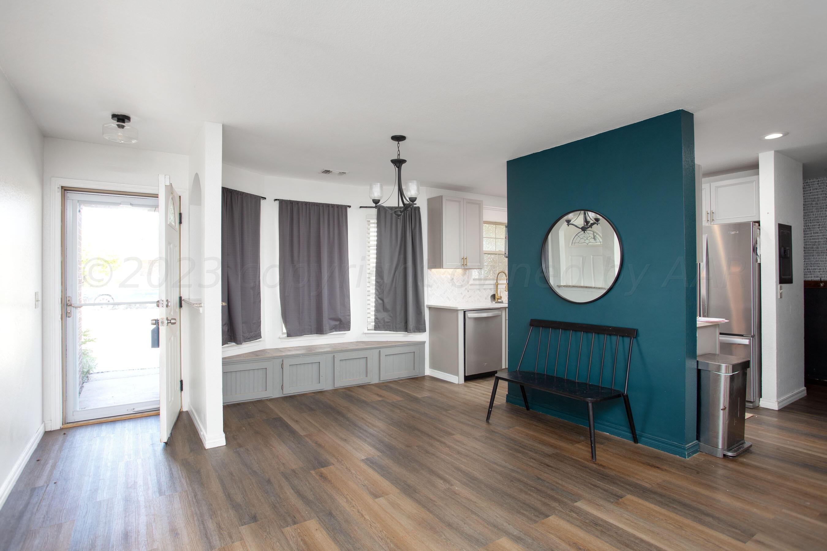 4511 South Roberts Street Amarillo, TX 79118 - Photo 5 of 26 a view of a room with wooden floor and window