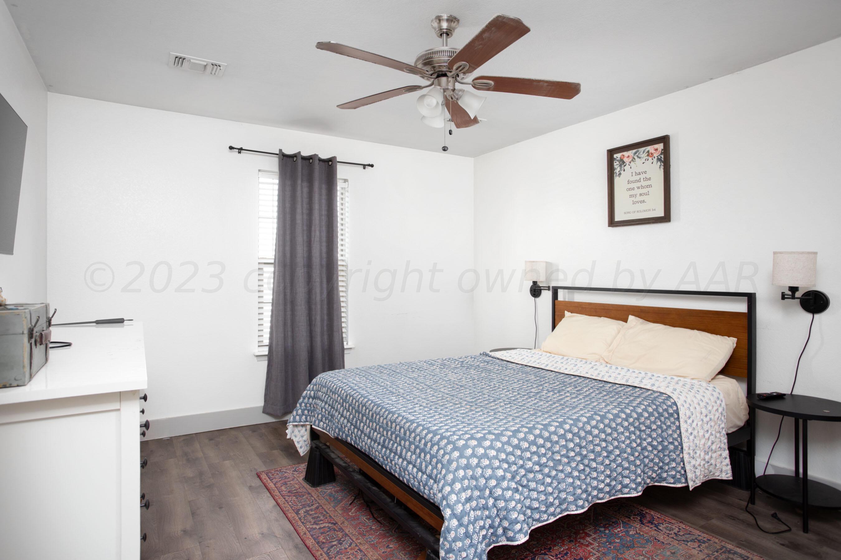 4511 South Roberts Street Amarillo, TX 79118 - Photo 10 of 26 a bedroom with a bed and a flat screen tv