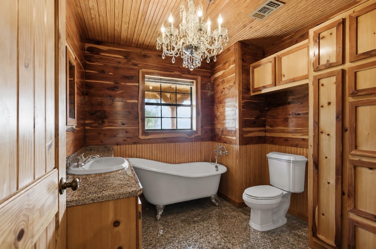 27185 Muckelroy Road Hempstead, TX 77445 - Photo 20 of 48 a bathroom with a granite countertop sink toilet and shower