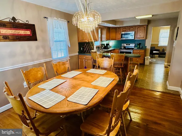 a view of a dining room with furniture and a chandelier