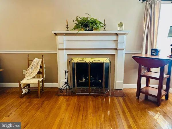 a view of living room with furniture and a fireplace
