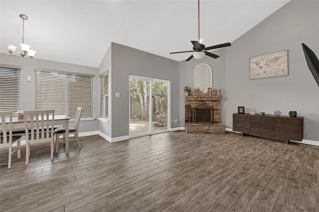 a view of a livingroom with furniture and chandelier wooden floor