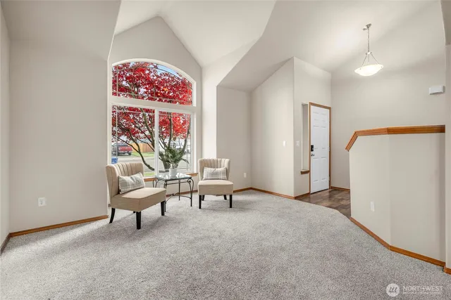 a living room with furniture and a chandelier