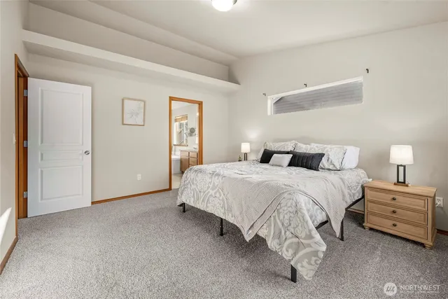 a bedroom with a bed and a night stand