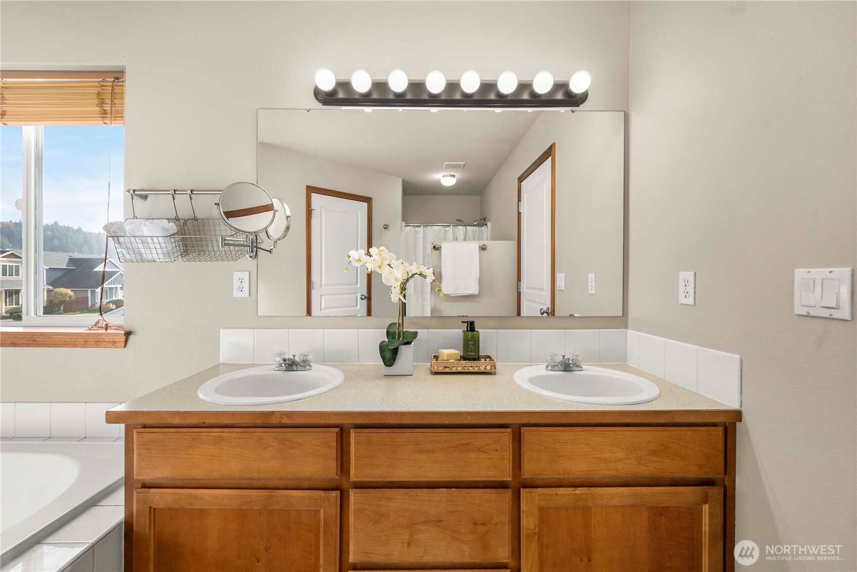 1503 Riddell Avenue Northeast Orting, WA 98360 - Photo 21 of 40 a bathroom with a sink and a mirror