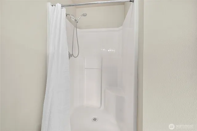 a bathroom with a glass shower door