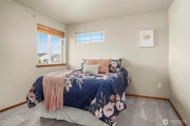 a bed sitting in a bedroom next to a window
