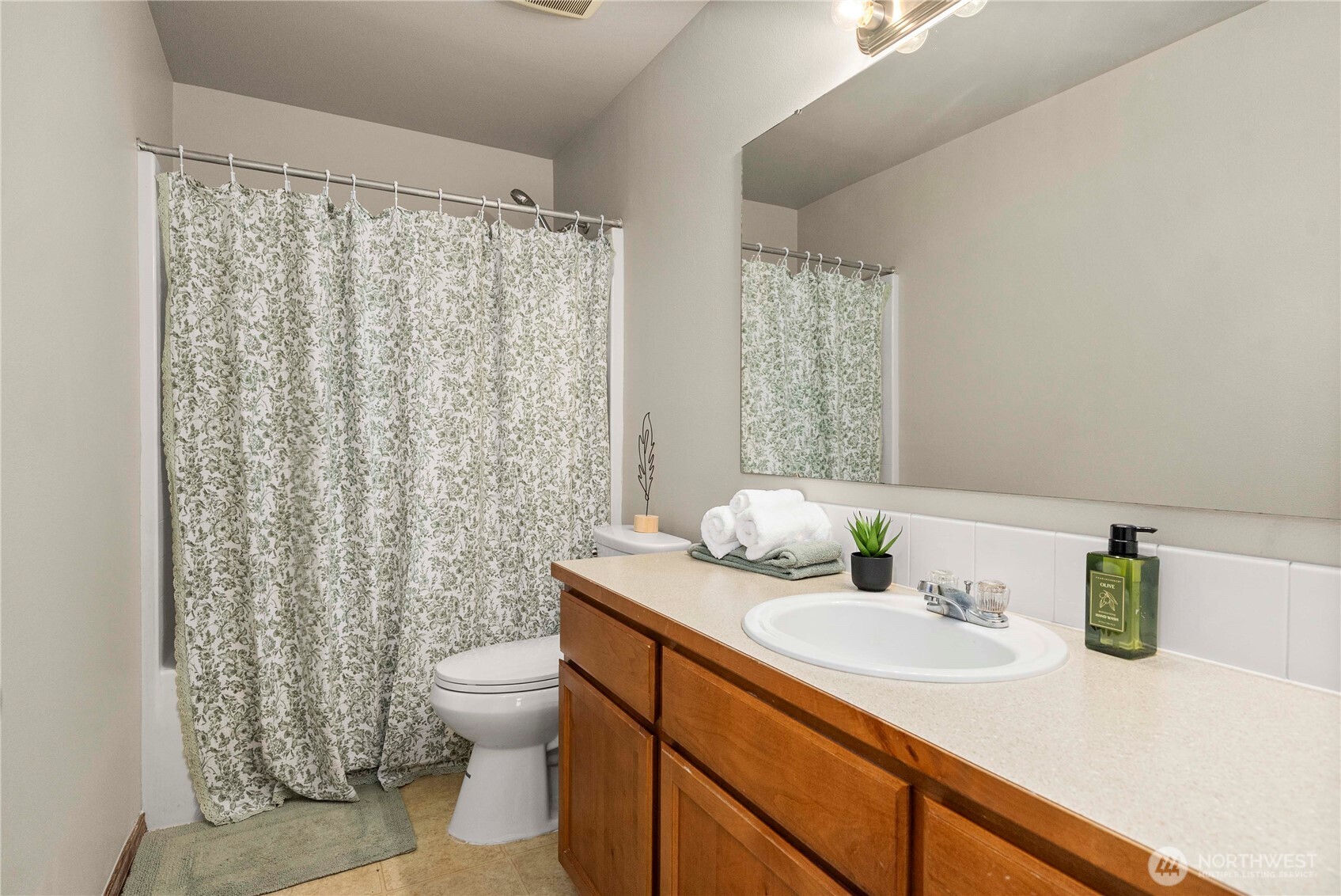 1503 Riddell Avenue Northeast Orting, WA 98360 - Photo 27 of 40 a bathroom with a granite countertop sink a toilet and a shower